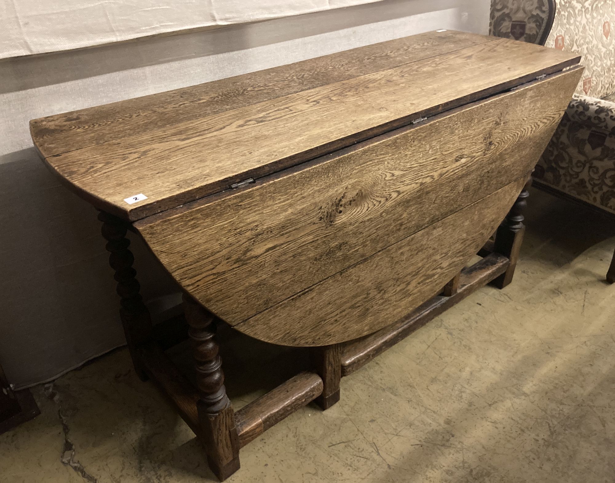 An 18th century oak gateleg dining table, 159cm extended, width 140cm height 78cm